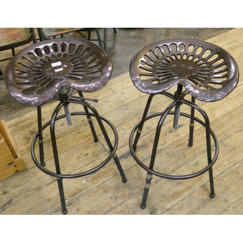 72 - A pair of copper finished iron tractor seat kitchen stools