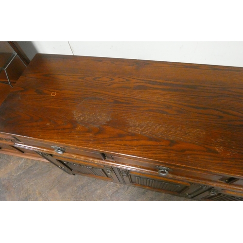 94 - An Old Charm oak sideboard fitted three drawers and linen fold panel cupboards, 4'6 wide