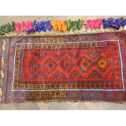 170 - A red and patterned wool pile saddle bag rug, 3'9 X 1'11 approximately