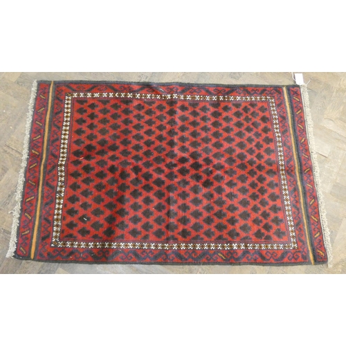 171 - A red and patterned tree design wool pile rug, 4'8 X 2'10