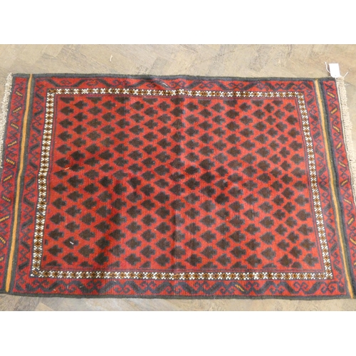 171 - A red and patterned tree design wool pile rug, 4'8 X 2'10