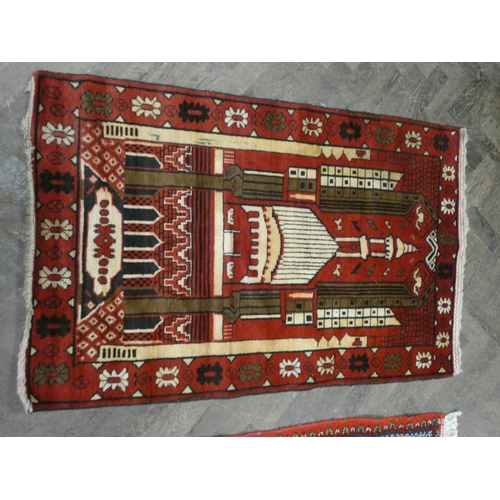 172 - A red and patterned design wool pile rug, 4'10 x 3' approximately