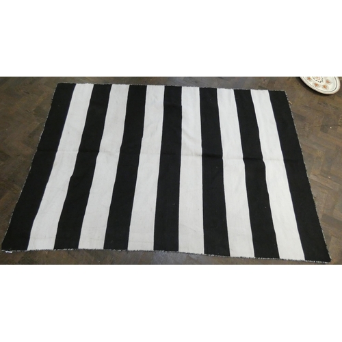 180 - A black and white striped design Kilim style wool pile rug, 7'7 X 5'1 approximately