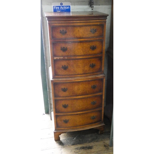 1 - A small Georgian style figured walnut bow front tallboy chest of six drawers with brass handles.