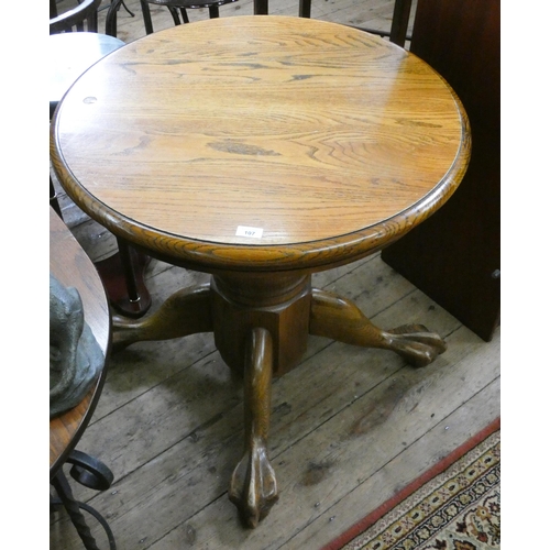 107 - A circular oak table on heavy pillar and foot stand, 2'6 diameter