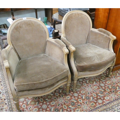 112 - A pair of tub shaped elbow chairs with brown upholstery and loose cushions