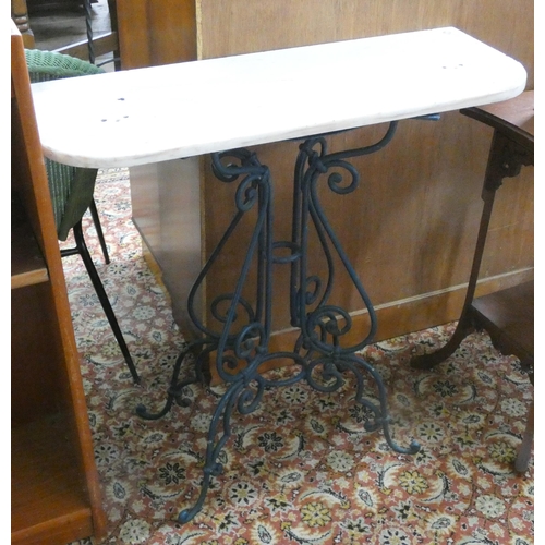 121 - A marble topped side table on iron base, 2'9 wide