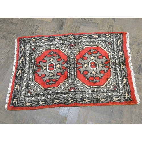 149 - A red and patterned Afghan style wool pile rug and a striped wool pile rug