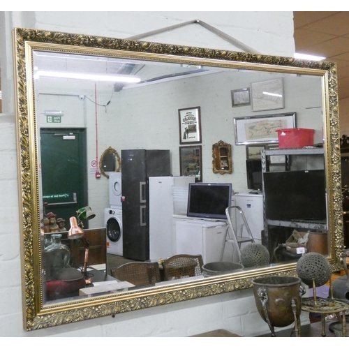 166 - A very large bevelled wall mirror in decorative frame, 52