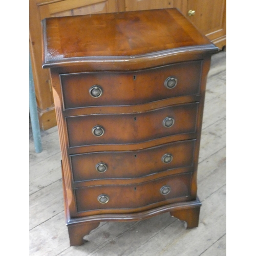 18 - A small Georgian style serpentine front yew wood chest of four drawers, 20