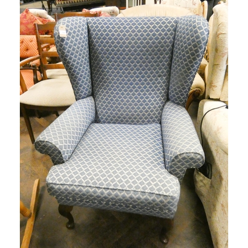 184 - A blue and patterned wing backed easy chair with cabriole front legs