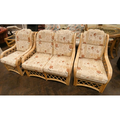 196 - A two seater bamboo framed three piece conservatory suite with loose floral patterned cushions, toge... 