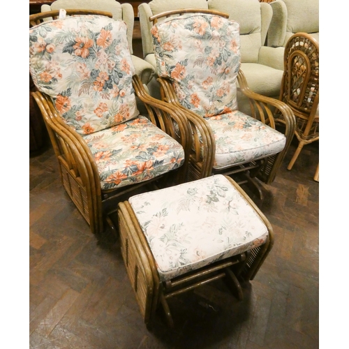 232 - A pair bamboo framed rocking conservatory chairs with loose floral cushions and similar rocking foot... 