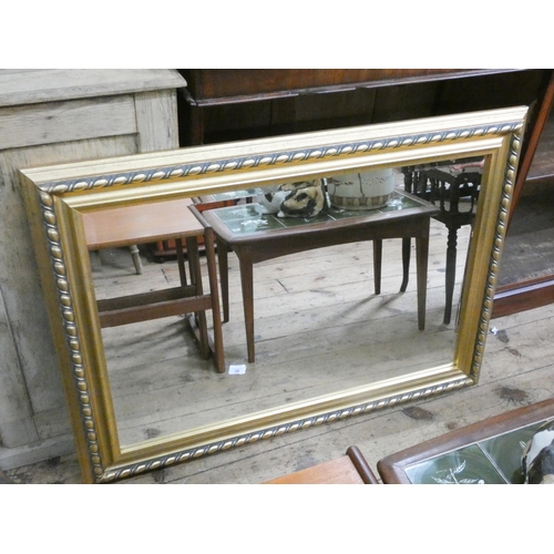 39 - A large bevelled wall mirror in decorative gilt frame