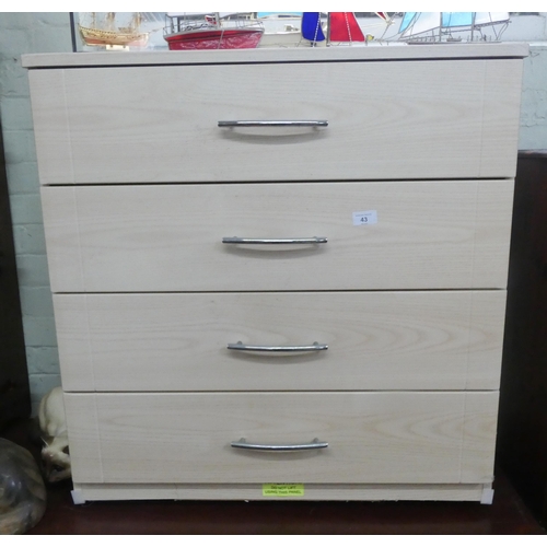 43 - A modern pale pine effect chest of four long drawers, 2'6 wide