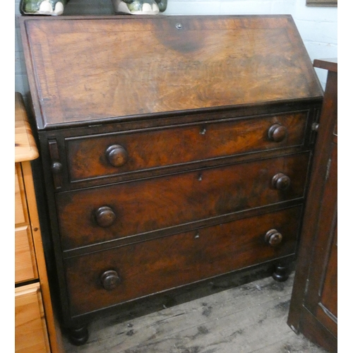 48 - A Georgian mahogany bureau with three long drawers under and later Victorian bun handles, 3' wide