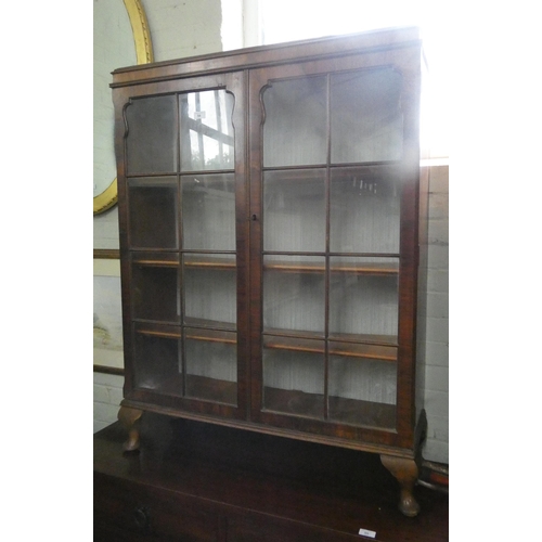 54 - A walnut glazed two door bookcase on cabriole feet 3' wide