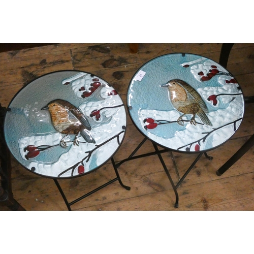 67 - A pair of small metal framed tables with coloured glass bird decorated tops