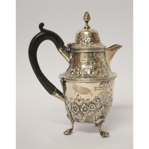 541 - A café au lait jug, with engraved and embossed floral swag decoration, on three paw feet. 14 cms tal... 