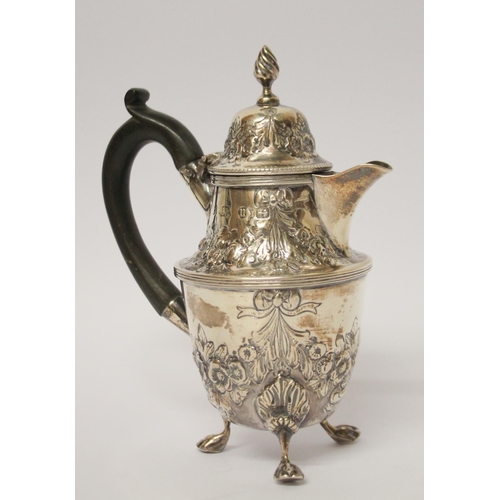 541 - A café au lait jug, with engraved and embossed floral swag decoration, on three paw feet. 14 cms tal... 