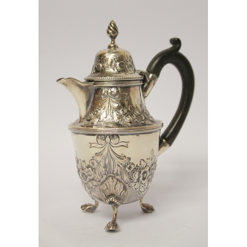 541 - A café au lait jug, with engraved and embossed floral swag decoration, on three paw feet. 14 cms tal... 