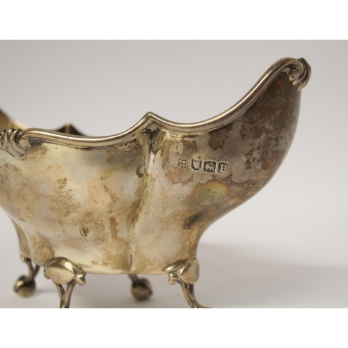 549 - A silver shaped sweetmeat basket, standing of four ball and claw feet. London 1910. 18cms across, 5.... 