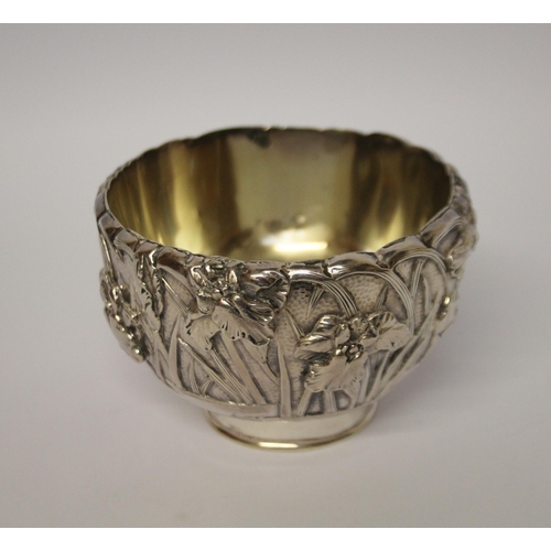 555 - A Japanese silver sugar basin, the exterior cast with iris, gilded interior. Character marks to base... 