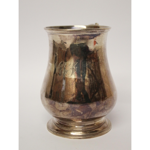 556 - A Victorian silver pint tankard, shallow engraved initials. London marks Henry Holland, 1865. 12 cms... 