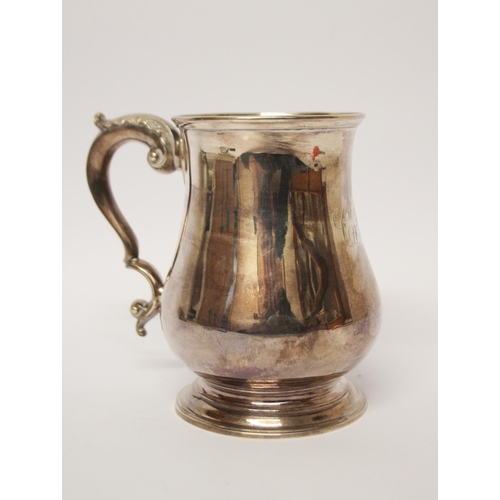 556 - A Victorian silver pint tankard, shallow engraved initials. London marks Henry Holland, 1865. 12 cms... 