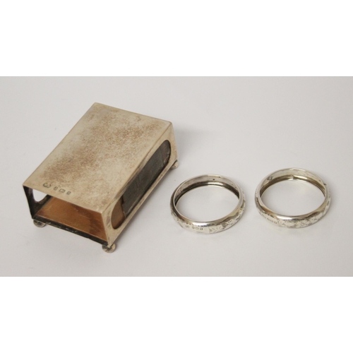 557 - A silver matchbox holder and a pair of silver napkin rings.