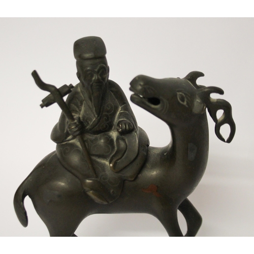 320 - A Chinese bronze figure of a sage astride an antelope, 7