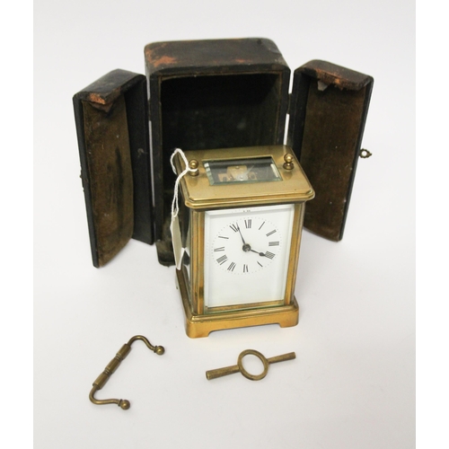 327 - A French gilt brass carriage clock with key and leather case, handle currently detached