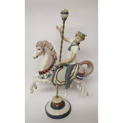 330 - Lladro figurine of a boy riding a carousel horse, approximately 40cms tall