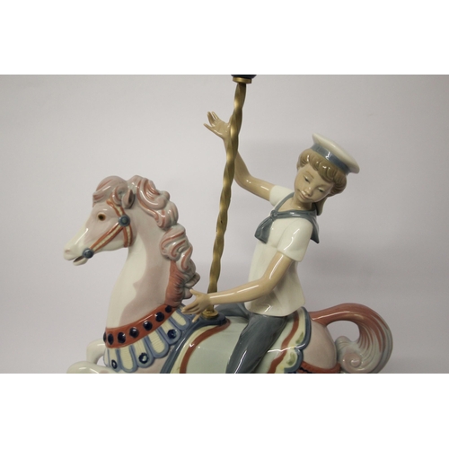 330 - Lladro figurine of a boy riding a carousel horse, approximately 40cms tall