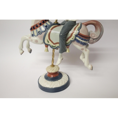 330 - Lladro figurine of a boy riding a carousel horse, approximately 40cms tall