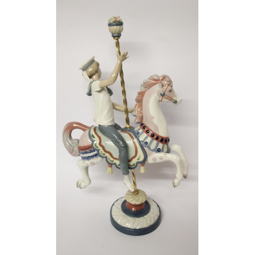 330 - Lladro figurine of a boy riding a carousel horse, approximately 40cms tall