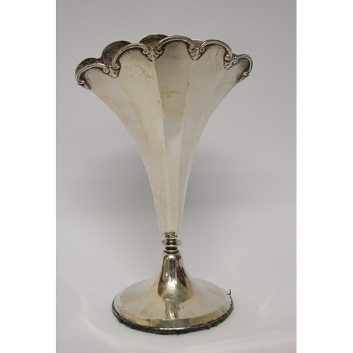 544 - A fan shaped silver trumpet case, on circular weighted base. Approx 18 cms tall