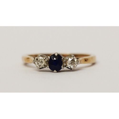 594 - A three stone sapphire and diamond ring, on 18ct yellow gold band. Ring size K