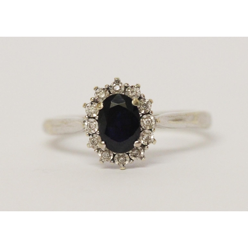 598 - A sapphire and diamond oval cluster ring, on hallmarked 9ct white gold band, ring size R