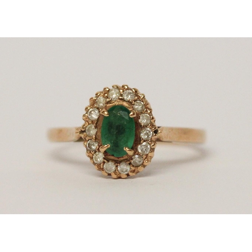 599 - An emerald and diamond oval cluster ring, on 9ct yellow gold band, unmarked, ring size L 1/2