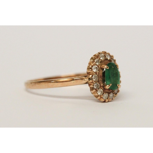 599 - An emerald and diamond oval cluster ring, on 9ct yellow gold band, unmarked, ring size L 1/2