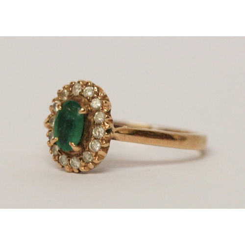 599 - An emerald and diamond oval cluster ring, on 9ct yellow gold band, unmarked, ring size L 1/2