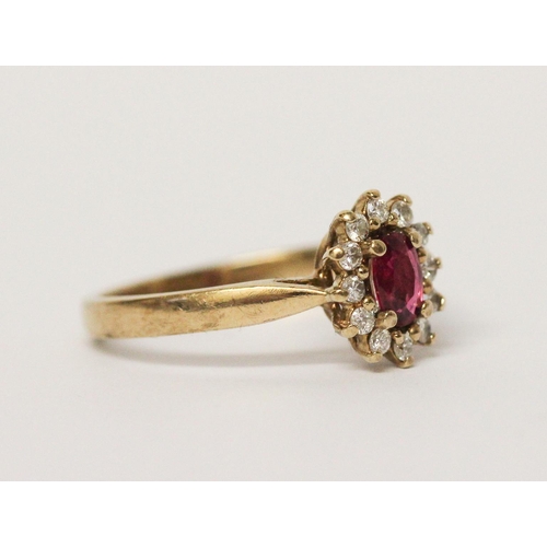 614 - Modern ruby and diamond oval cluster ring on 9ct yellow gold band, ring size M