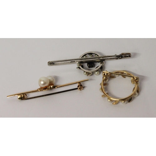 618 - A 9ct gold bar brooch set two cultured pearls, a pearl set 9ct gold wreath brooch and a 9ct white go... 