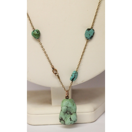 621 - A 1920's gold and turquoise nugget pendant necklace, approximately 65 cms long. Clasp marked '9ct'.