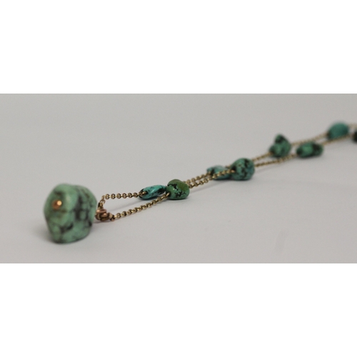 621 - A 1920's gold and turquoise nugget pendant necklace, approximately 65 cms long. Clasp marked '9ct'.