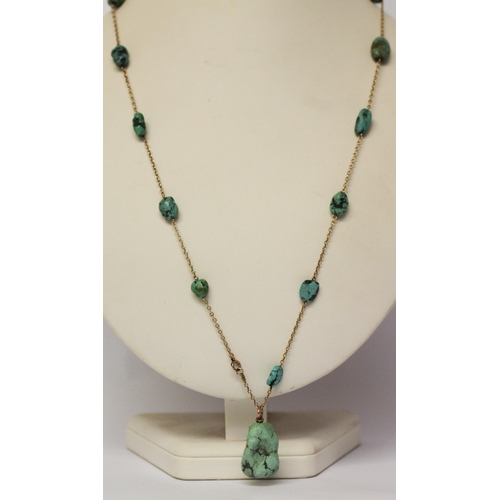 621 - A 1920's gold and turquoise nugget pendant necklace, approximately 65 cms long. Clasp marked '9ct'.