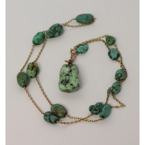 621 - A 1920's gold and turquoise nugget pendant necklace, approximately 65 cms long. Clasp marked '9ct'.