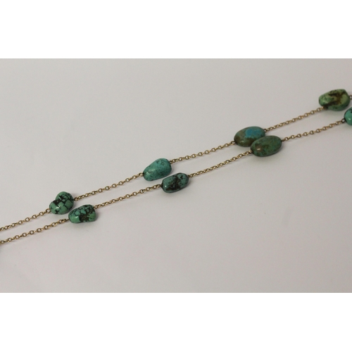 621 - A 1920's gold and turquoise nugget pendant necklace, approximately 65 cms long. Clasp marked '9ct'.