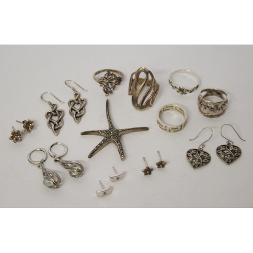 622 - A collection of silver earrings, marcasite starfish pendant and five ladies silver dress rings.